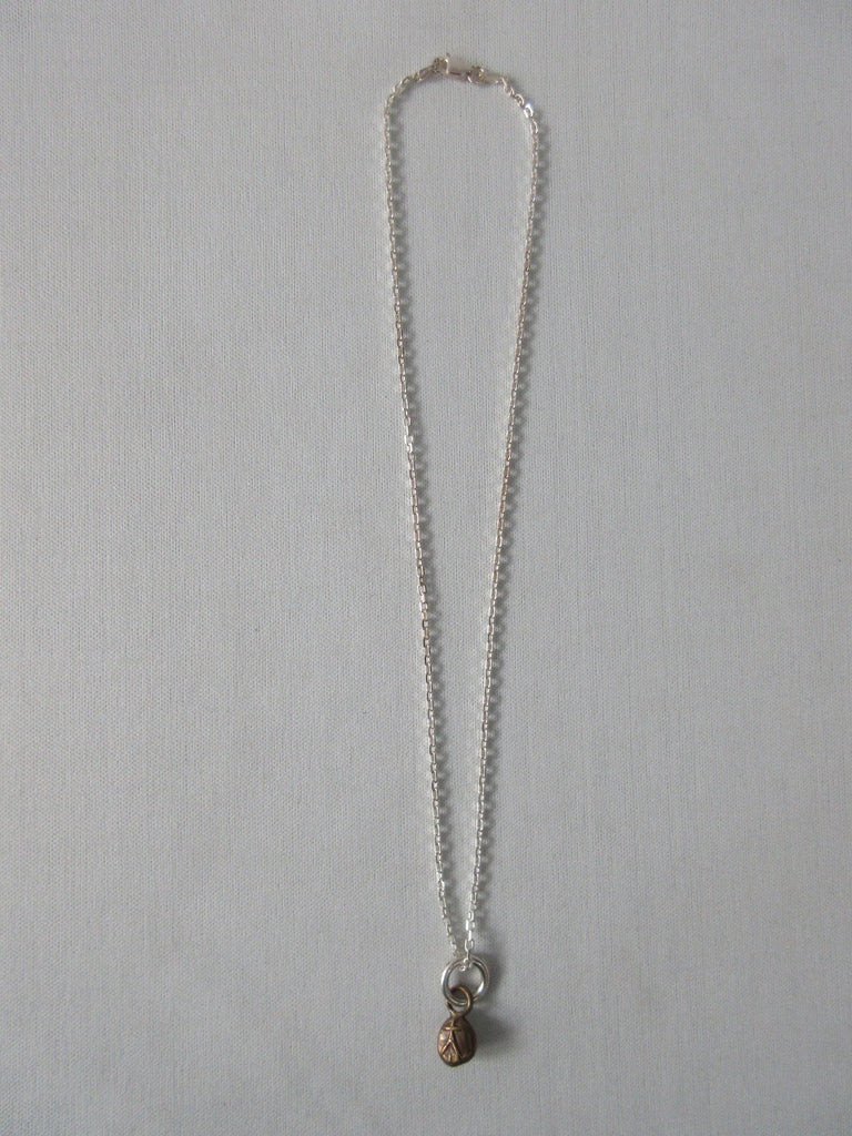 20A63 Brass Person Figure Steel Necklace Brass person attached to stainless steel chain. Full length when worn 25cm. 12 grams approximate weight.