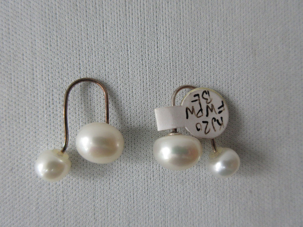Double Pearl Style Earrings. With curved brass attaching. One pearl unscrewed to put on. Extra piece included x3 pieces total. 5 grams approximate weight. Large pearl .8cm width Small pearl: .6cm width