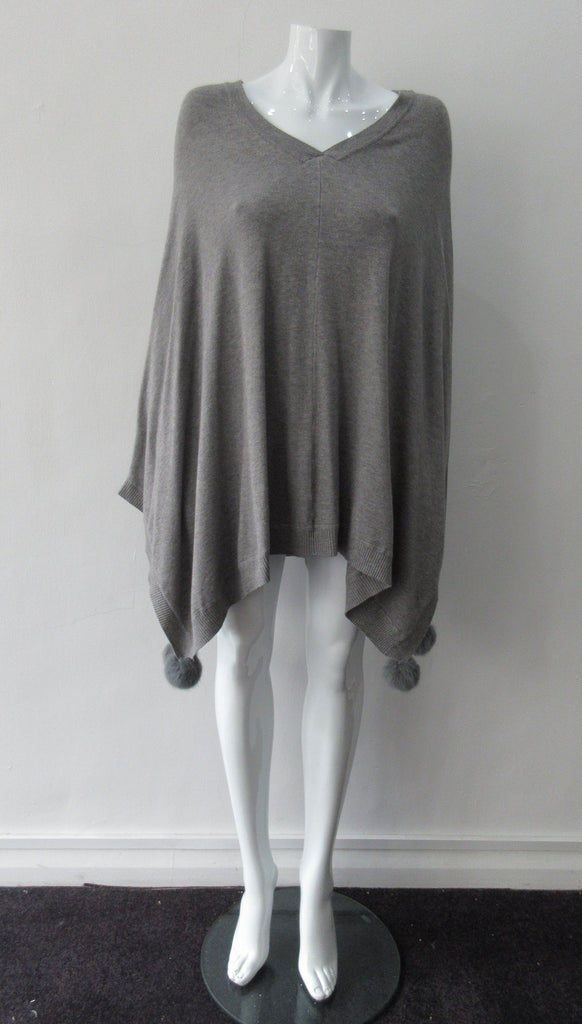 Generous cut swing poncho for greater ease and comfort. 4 fuzz balls located at corner points. Art. 4461, 52% Viscose, 35% Modal, 8% Elastic, 5% Cashmere, Dry Clean Only, Made in Italy, CB Length 81cm approximate length.