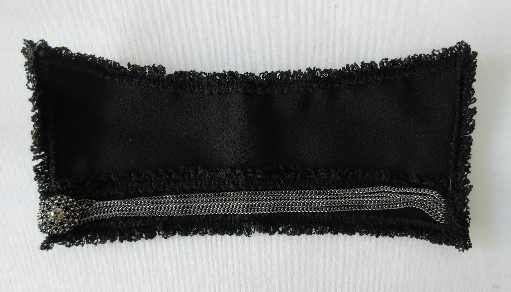 Catherine Osti Black Crepe & Chains Cuffs. Black Wool Crepe with Metal Chains and Shiny Accent Button. Snap Clousre. 19.5cm width between snaps. 60g approximate weight, comes in white box. Made in France