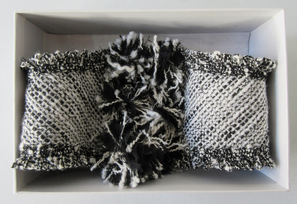 Black & White Tweed style weave, with frayed detail on edge, 100% wool with 100% Cotton inner back lining. Snap Closure. Size M -17cm from snap to snap width Size L -18cm from snap to snap width. 60g approximate weight, comes in white box. Made in France