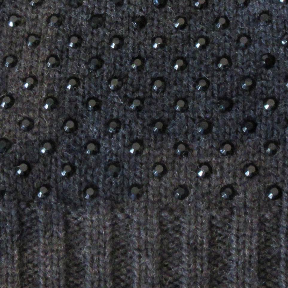 Charcoal Dark Crystal Hat. Knit Cap in Charcoal with mini Swarowski crystals on front. Crystals can be displayed full front or worn sideways. Article 90717 TG A/M. Width 22cm, Height 21cm. 50g approximate weight. 100% Wool Hand wash, Hang dry only. Made in Italy