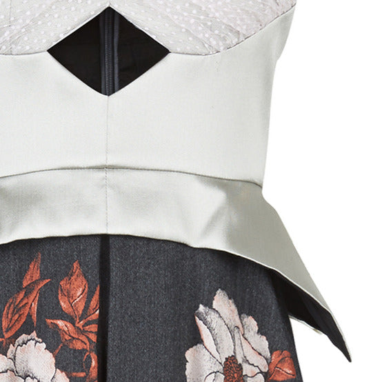 Sleevelss dress combination of ruched bust area with silver thin peplum aspect. Gathered flounces on lower dress adds volume and greater movement. Small gap in middle of bust. 600g approximate weight. 41% Polyester, 26% Acrylic, 26% Wool, 7% Polyamide. Contrast: 100% Nylon. Dry Clean Only. Made in England