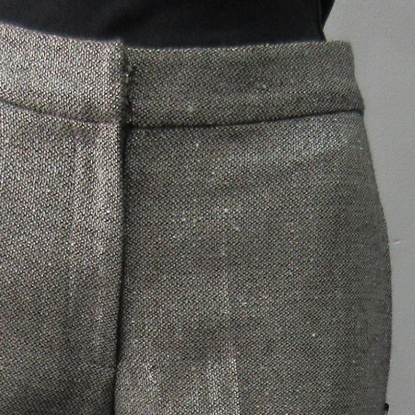 Soft micro-tweed with slight shine. 53% Wool, 31% Viscose, 14% Silk, 2% Polyeurathane. Size 8, Inseam 82.5cm, Outseam 102cm, Dry Clean Only, Made in England.