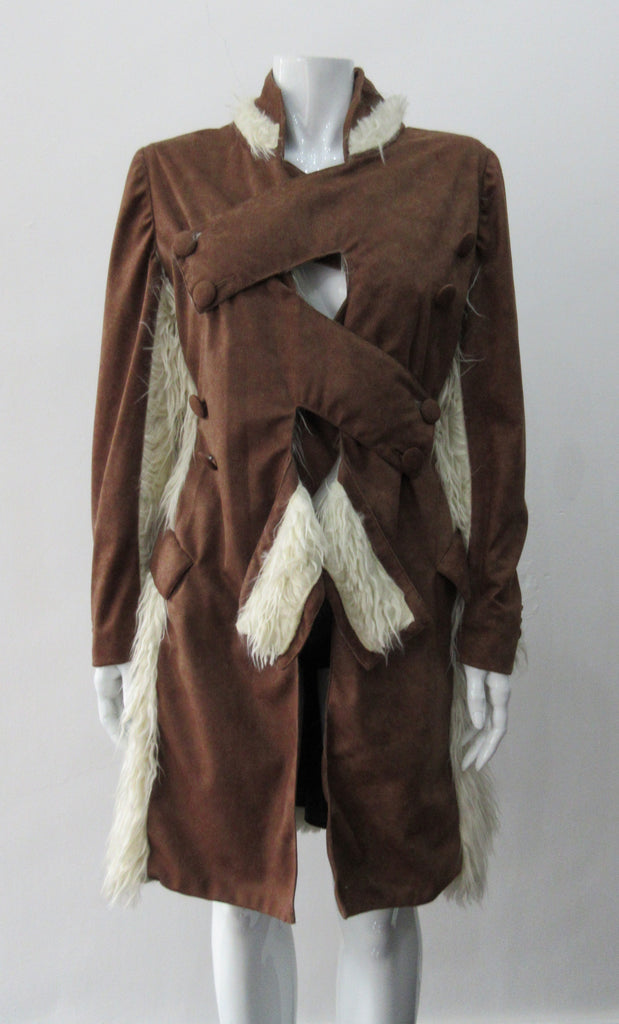 Split Suede Coat. Faux suede coat with faux fur contrast trim on lapels and inside. Flared towards hem with contrast faux fur panels. Rich saddle lighter brown colour. Feminine version inspired from 18th century men's evening coat. Multiple ways of buttoning as illustrated. Can be paired with 060301 Brown Suede Trouser. Formerly a showpiece, specially made. No Label. CB Length 94cm. Sleeve length from side shoulder point 75cm. 850g approximate weight. 95% Polyester, 5% Rayon. Contrast: 100% Viscose.  Dry Cl