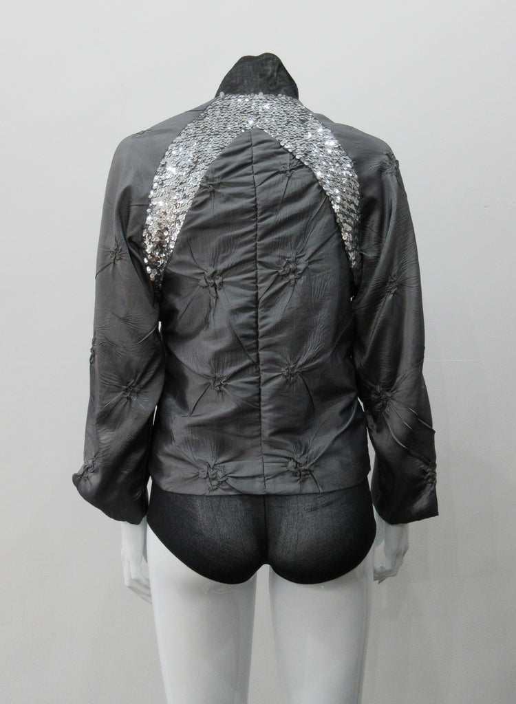 Grey Sparkle Raglan Panel Zip Jacket. Featuring pinched satin fabric and brilliant sequin panel on both front and back sides. CF zipper and 8cm high contrast collar. CB length 56cm. Sleeve length from side neck point 66cm. 220g approximate weight. 60% Polyester, 30% Viscose, 10% Nylon. Lining: 100% Rayon. Dry Clean Only. Made in Canada