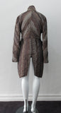 Brown Wave Cut Away Coat. Mid 19th Century military style cut-away coat in textured array of brown & brass. Slight reptile print covered with sheer stripe fabric pieces. CF cutaway and 29cm. CB slpit open back vent at hem. 2 button closure. CB length from neck point 91cm. Sleeve length from side neck point 80cm. 700g approximate weight. 75% Polyester, 25% Nylon Lining: 100% Rayon. Dry Clean Only. Made in Canada