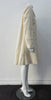 Generously cut 3/4 length coat with large rounded collar and covered buttons in off white, with a slight military feel. Features neo-classical trim design which naturally becomes fuzzy over time as a design detail. Size 12