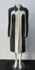 Full length coat featuring charcoal and white contrast panels. 5 covered buttons on centre front.