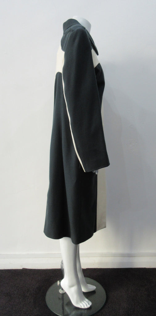 Full length coat featuring charcoal and white contrast panels. 5 covered buttons on centre front.