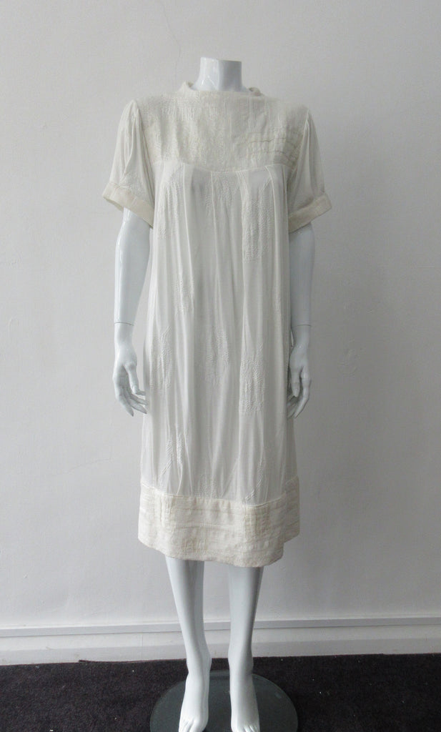 Half Pleat Dress:  Art-Nouveau style with pleats to add fullness into tapered hem. Invisible zipper on shoulder. Falls mid calf  Size 8. CB Length 105cm, 350g approximate weight. 62% Viscose, 20% Wool, 15 %Silk, 3% Cotton Contrast: 46% Modal, 34% Nylon, 10% Angora, 10% Viscose, Dry Clean Only, Made in Croatia