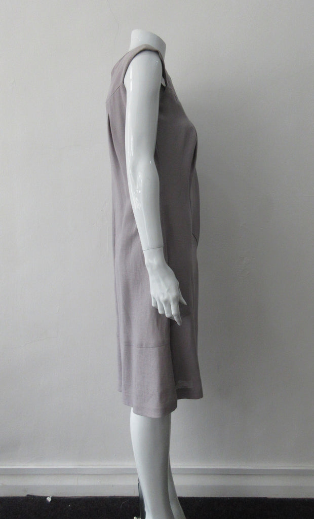 Pleated Cross Seam Dress. Blue-Grey dress with cross seam panel details. Falls below the knee. 65% Linen, 35% Cotton. Contrast: 58% Nylon, 42% Polyester Lining: 100% Rayon Dry Clean Only. 250g approximate weight. Made in Croatia