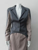Cropped Point Sleeve Jacket. Pointed peak collared cropped style in grey with light taupe/rose contrast sleeve panels. Relaxed fit with soft raglan sleeves. Shown with matching skirt. Size 8. 100% Wool. Lining: 100% Rayon, Dry Clean Only. Made in England