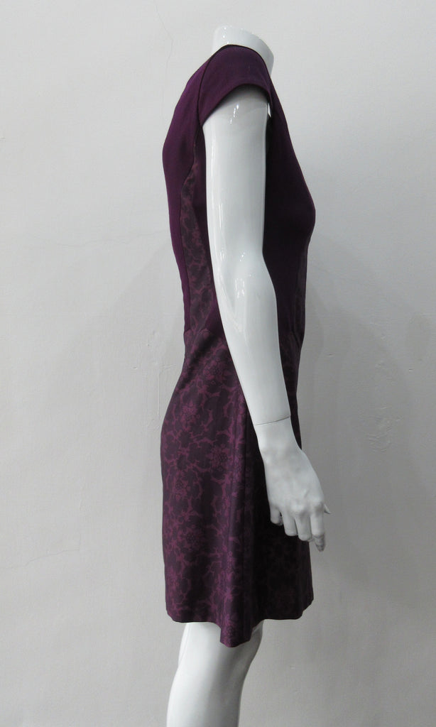 Pointed Tip Dress. Rich purple wool dress with matching floral book print contrast panels and base. Soft cap sleeve top and CB zipper. CB Length 82cm. 550g approximate weight. 100% Wool. Contrast: 100% Cotton, Lining: 100% Rayon. Dry Clean Only, Made in England