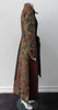 Belted Coat.  Full length multi-textured, multi-paneled coat in a variety of brocades in gold, brass, red & black. CF metal zipper concealed behind black satin trim.  4.5cm tie belt attached to coat at side seams. 59cm side hem slits.  Reverse pleats on front below waist for bit more ease. CB Coat length 131cm. Sleeve length from side neck point 78cm. 48% Acetate, 32% Cotton, 10% Viscose, 10% Lurex. Contrast: 65% Cotton, 35% Polyester. Lining 100% Rayon. Dry Clean Only. Made in England