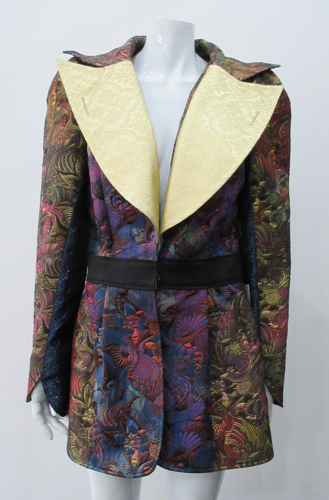Romanov Jacket. Huge collared bright gold lapel long jacket in a multitude of textured fabrics. Lower waistband trim panel with double hook front closure. CB jacket length 77cm. Sleeve length from side neck point 80cm. 400g approximate weight. 65% Cotton, 35% Polyester. Contrast: 48% Acetate, 32% Cotton, 10% Viscose, 10% Lurex. Lining: 100% Rayon. Dry Clean Only. Made in England