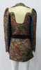 Romanov Jacket. Huge collared bright gold lapel long jacket in a multitude of textured fabrics. Lower waistband trim panel with double hook front closure. CB jacket length 77cm. Sleeve length from side neck point 80cm. 400g approximate weight. 65% Cotton, 35% Polyester. Contrast: 48% Acetate, 32% Cotton, 10% Viscose, 10% Lurex. Lining: 100% Rayon. Dry Clean Only. Made in England