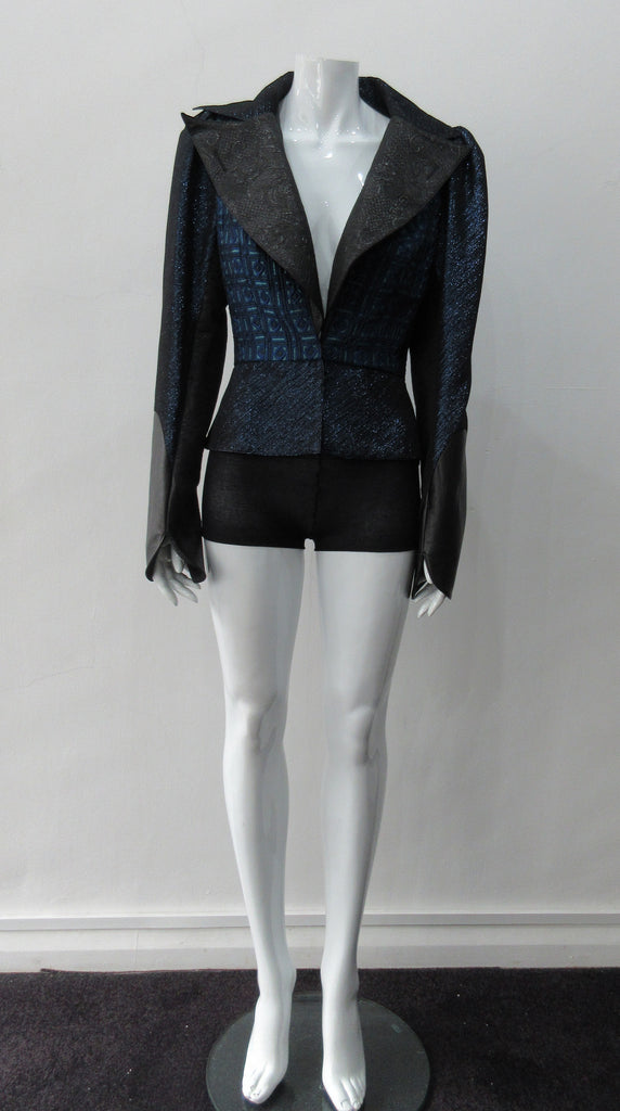 Romanov Crop Jacket. Cropped big lapelled jacket in electric deep blue combination of fabrics & textures. Featuring CF clip at waist. Leather cuffed sleeve hems. CB length 52cm. 200g approximate weight. 59% Cotton, 41% Nylon. Contrast: 41% Viscose, 37% Acrylic, 22% Nylon. Lining: 100% Rayon. Dry Clean Only. Made in England