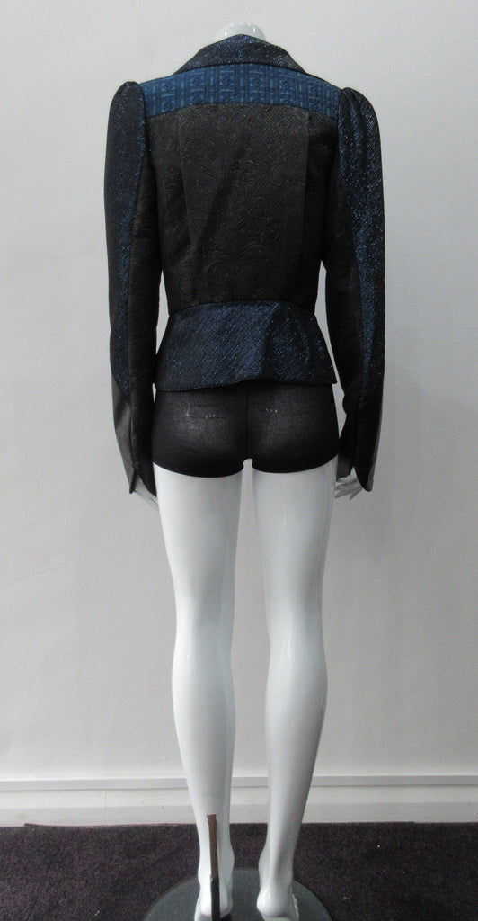 Romanov Crop Jacket. Cropped big lapelled jacket in electric deep blue combination of fabrics & textures. Featuring CF clip at waist. Leather cuffed sleeve hems. CB length 52cm. 200g approximate weight. 59% Cotton, 41% Nylon. Contrast: 41% Viscose, 37% Acrylic, 22% Nylon. Lining: 100% Rayon. Dry Clean Only. Made in England