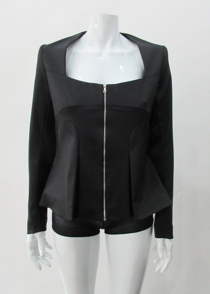 Dark Corset Jacket. Geometric cut lower front metal zip jacket with flared peplum-style hem in medium length. Designed for a tighter fit around the bust area. In solid black with slight stretch. CB length 63cm. Sleeve length from side neck point 78cm. 750g approximate weight. 95% Polyester, 5% Spandex Lining: 100% Viscose. Dry Clean Only. Made in England