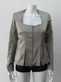 Corset Jacket. Geometric cut lower front metal zip jacket with flared peplum-style hem in medium length. Designed for a tighter fit around the bust area. In solid silver taupe colour with slight stretch. CB length 63cm. Sleeve length from side neck point 78cm. 750g approximate weight. 95% Polyester, 5% Spandex. Lining: 100% Viscose. Dry Clean Only. Made in England