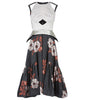 Sleevelss dress combination of ruched bust area with silver thin peplum aspect. Gathered flounces on lower dress adds volume and greater movement. Small gap in middle of bust. 600g approximate weight. 41% Polyester, 26% Acrylic, 26% Wool, 7% Polyamide. Contrast: 100% Nylon. Dry Clean Only. Made in England