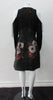 Black Tie Sleeve Dress. Black floral design print dress with cut-away shoulders and pointed tips at neckline, connected with contrast string. Shoulder strings provide gathering capabilities as well. CB invisible zipper. CB dress length 97cm. 400g approximate weight. 93% Acrylic, 7% Polyester. Contrast: 41% Polyester, 26% Acrylic, 26% Wool, 7% Polyamide. Lining 100% Rayon. Dry Clean Only. Made in England