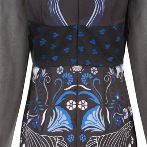 Full length multi-textured print dress featuring faux leather criss-cross paneling and black sheer sleeves. Semi-open top shoulders. Upper bodice has black with blue spotted design.