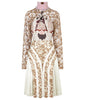 Print Tri-Point Dress. Sample sold as-is, no return, no refund. Contrast sequined and beaded gold lace contrast panels. Subtle floral print design on bodice. Full pleats below hip. CB invisible zipper. High ruched collar.