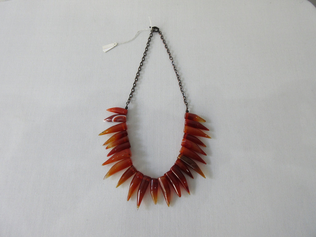 Tiger tooth pointed crystals in deep and blood orange colours. Smooth texture.