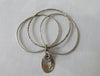 Karyn Chopik Multi 3 Ring Bracelet with Hollow Teardrop and Crystal Ring, 3 Sterling Silver Rings, 1 textured with Brass Ring attachment Size: Medium x1 6.5cm Inside diameter. 35 grams approximate weight. Made in Canada