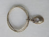 Karyn Chopik Multi 3 Ring Bracelet with Hollow Teardrop and Crystal Ring, 3 Sterling Silver Rings, 1 textured with Brass Ring attachment Size: Medium x1 6.5cm Inside diameter. 35 grams approximate weight. Made in Canada