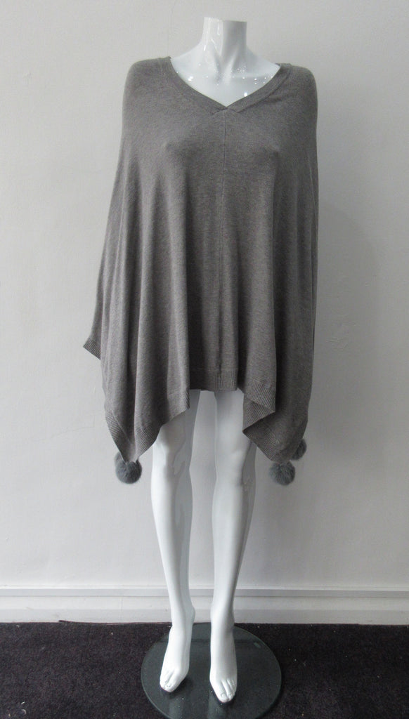 Generous cut swing poncho for greater ease and comfort. 4 fuzz balls located at corner points.  Art. 4461, 52% Viscose, 35% Modal, 8% Elastic, 5% Cashmere, Dry Clean Only, Made in Italy, CB Length 81cm approximate length.