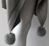 Generous cut swing poncho for greater ease and comfort. 4 fuzz balls located at corner points.  Art. 4461, 52% Viscose, 35% Modal, 8% Elastic, 5% Cashmere, Dry Clean Only, Made in Italy, CB Length 81cm approximate length.
