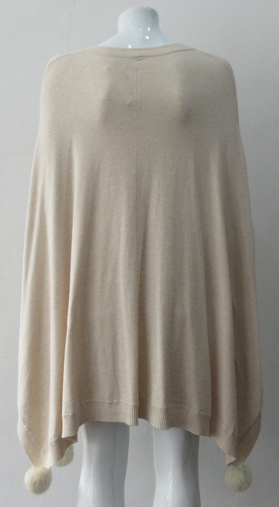 Generous cut swing poncho for greater ease and comfort. 4 fuzz balls located at corner points. Art. 4461, 52% Viscose, 35% Modal, 8% Elastic, 5% Cashmere. Dry Clean Only, Made in Italy, CB Length 81cm approximate.