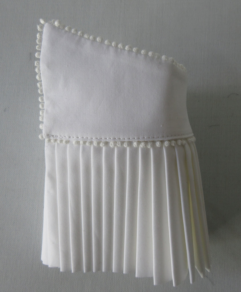 Catherine Osti White Pleated Cuffs 100% Cotton. Textured white, similar to dress shirt trim. Micro cotton ball trim on side and bottom. Snap Closure. Size M -18cm width from snap to snap Size L -20cm width from snap to snap, 60g approximate weight, comes in white box. Made in France