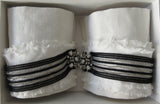 Catherine Osti White Linen with Stripe Trim Cuffs. 100% Unbleached Linen. Black & Silver stripe trim on base. Beaded Button top feature. Snap Closure. 19.5cm length snap to snap. 60g approximate weight, comes in white box. Made in France