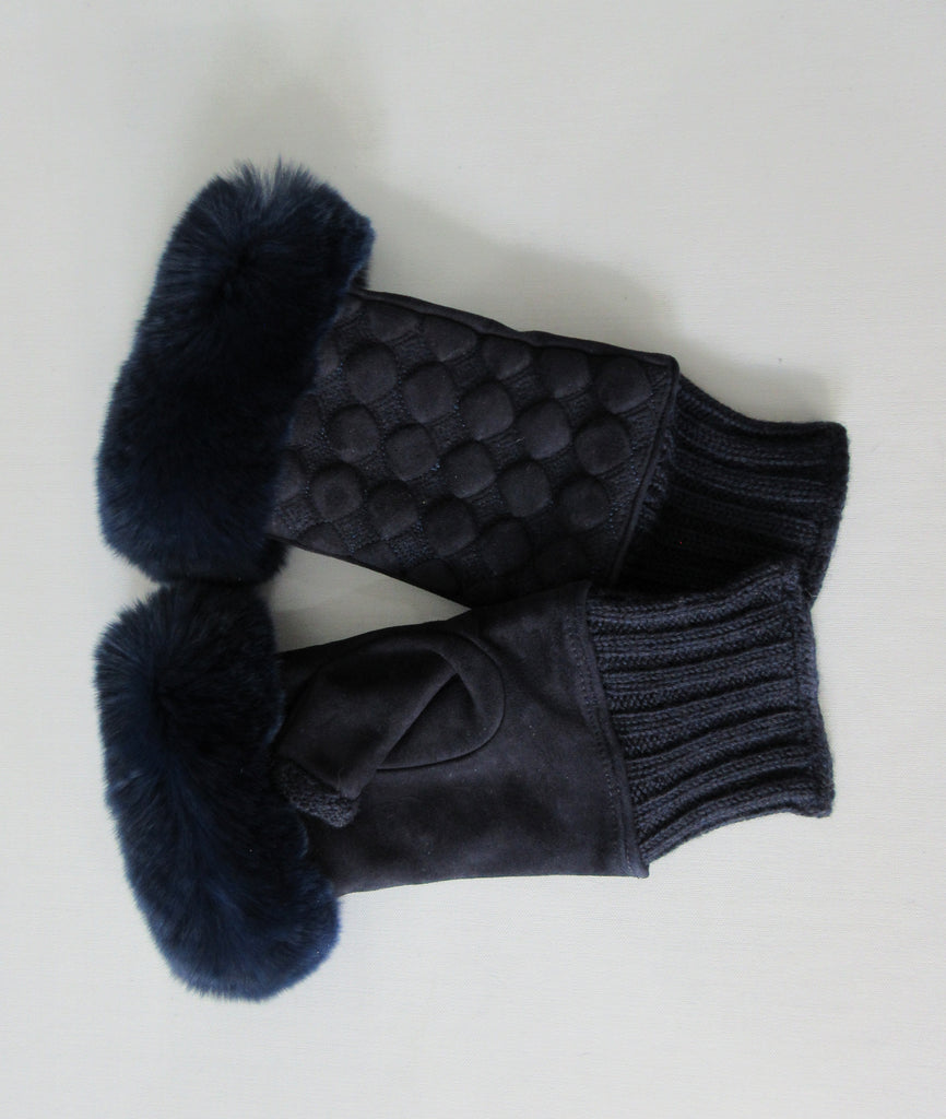 Gala Gloves Couture Navy Fingerless Gloves. Item Number D596SULA048 Blu. Navy Suede fingerless gloves with raised circular dot design, with fur trim for fingers. Navy knit base, suede gloves and fur trim. Made in Italy