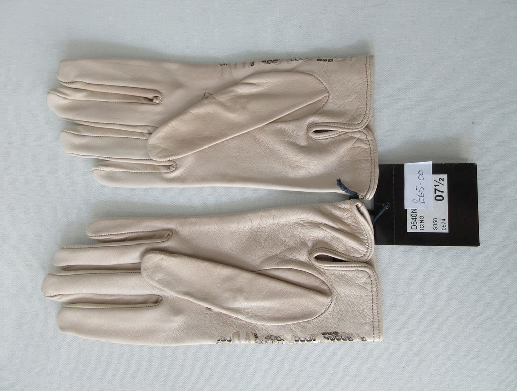 Beige Floral Cutout Gloves. Item Number D540NSF ICING 5358.0574. Beige Leather Gloves with floral cut-out design on top hand. Made in Italy. 60g approximate weight.