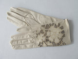 Tan Floral Cutout Gloves. Item Number D540NSF C1PRIA S357 0574. Tan Leather Gloves with floral cut-out design on top hand. 60g approximate weight. Made in Italy