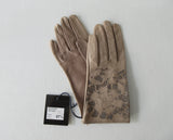 Taupe Floral Cutout Gloves. Item Number D54ONSF Tortora S359 0574. Taupe Leather Gloves with floral cut-out design on top hand. 60g approximate weight. Made in Italy