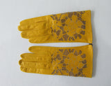 Yellow Floral Cutout Gloves. Item Number D540NSF Giallo Charo 6356.0574. Canary Yellow Leather Gloves with floral cut-out design on top hand. 60g aproximate weight. Made in Italy