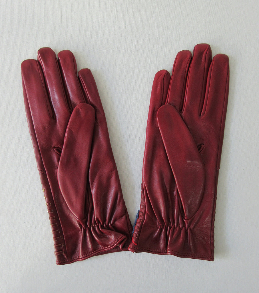 Gala Gloves Deep Red with Gold Studs Over Weave. Item Number D599NASE026 Rhum 948.001. Gold colour studs over weave design on top glove area. 60g approximate weight. Made in Italy