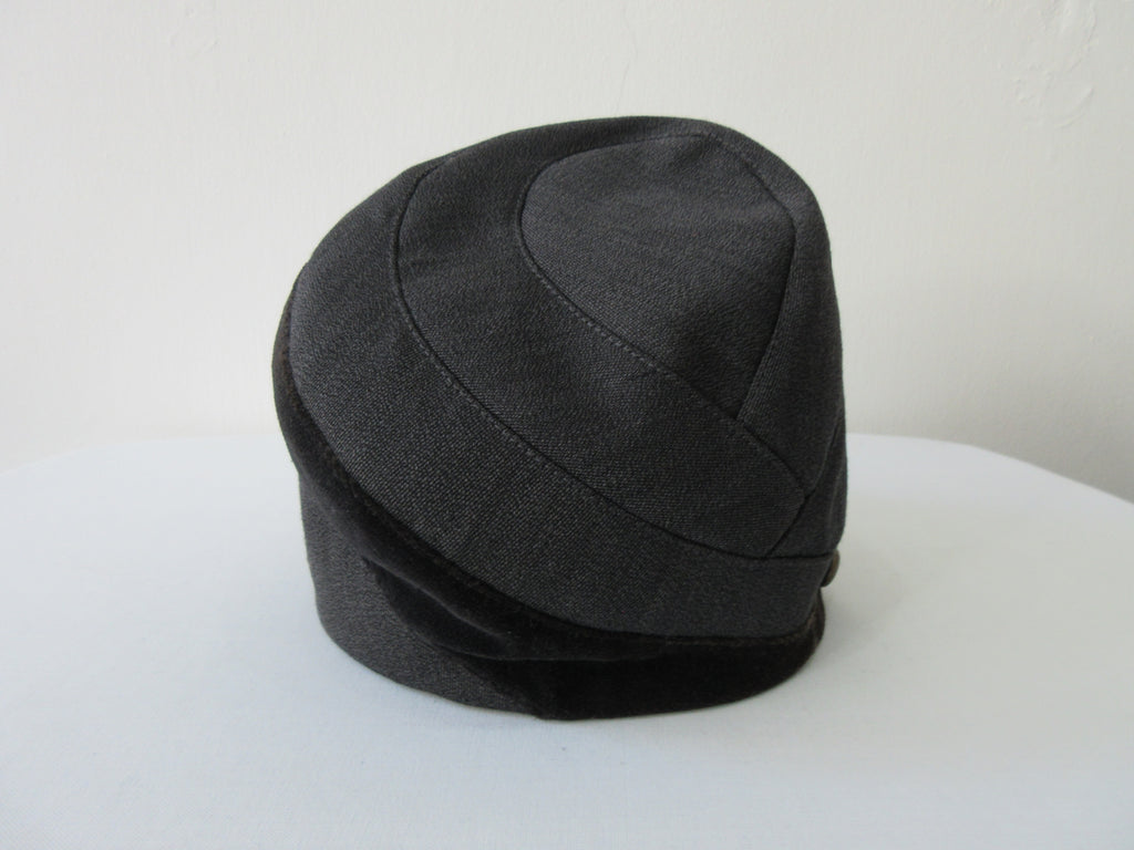 Karen Henricksen Savoy Hat. Heavy Charcoal coloured panels with velvet stripe. With 7 brass buttons. Bright green inside satin lining. Size unknown, inside diameter 59.5cm. Height 18cm in highest angle, 12cm on lowest angle. 35g approximate weight. Made in England