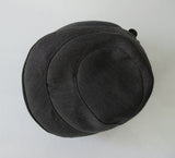 Karen Henricksen Savoy Hat. Heavy Charcoal coloured panels with velvet stripe. With 7 brass buttons. Bright green inside satin lining. Size unknown, inside diameter 59.5cm. Height 18cm in highest angle, 12cm on lowest angle. 35g approximate weight. Made in England