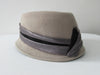 Olka Taupe Hat taupe colour felt with grey/black wrap around sash trim on brim. Size unknown, 57.5cm circumference. Height 12.5cm, Length 26.5cm, width 16.5cm. 26g approximate weight. 100% Wool. Made in Canada.