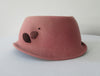 Olka Dusty Rose Hat with lace & mesh trim design. Size unknown. Inside circumfrence 59cm. Length 27cm. Width 20cm. Height 11.5cm back, 10.5cm front. 26g approximate wight. 100% Wool. Made in Canada