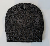 Regina Black Big Bead Hat with Silver Sparkles. Knit Cap in Black with large black beads combined with linear spread shiny mini Swarowski crystals on front. Crystals can be displayed full front or worn sideways. Article 90754 TG A/M Nero. Width at base 19cm, Height 22cm. 55g approximate weight. 100% Wool Hand wash, Hang dry only. Made in Italy