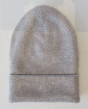 Regina Light Grey Alumino Silver Crystal Hat. Thicker lined light grey knit hat with silver Swarowski crystals. Crystals can be displayed full front or worn sideways. 8cm folding width. Article 90733 SUS8 TG A/M Alumino. Width 21cm. Height 24cm. 60g approximate weight. 100% Wool Hand wash, Hang dry only. Made in Italy
