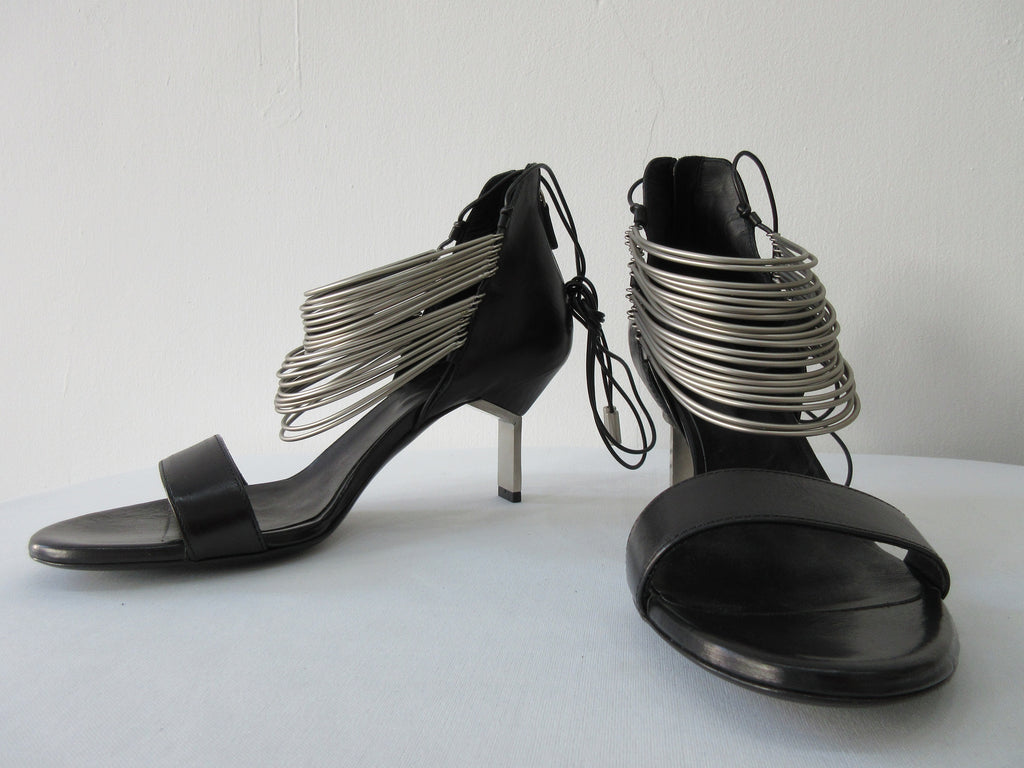 Vic Matie Black Curved Metal Heels, Product Number: Vic Matie 1N7002D.NB2CDZB323 Sandalo Modig/Acess 101/109, 4cm metal heel. 100% Leather with Stainless Steel rings and inside laces. Made in Italy